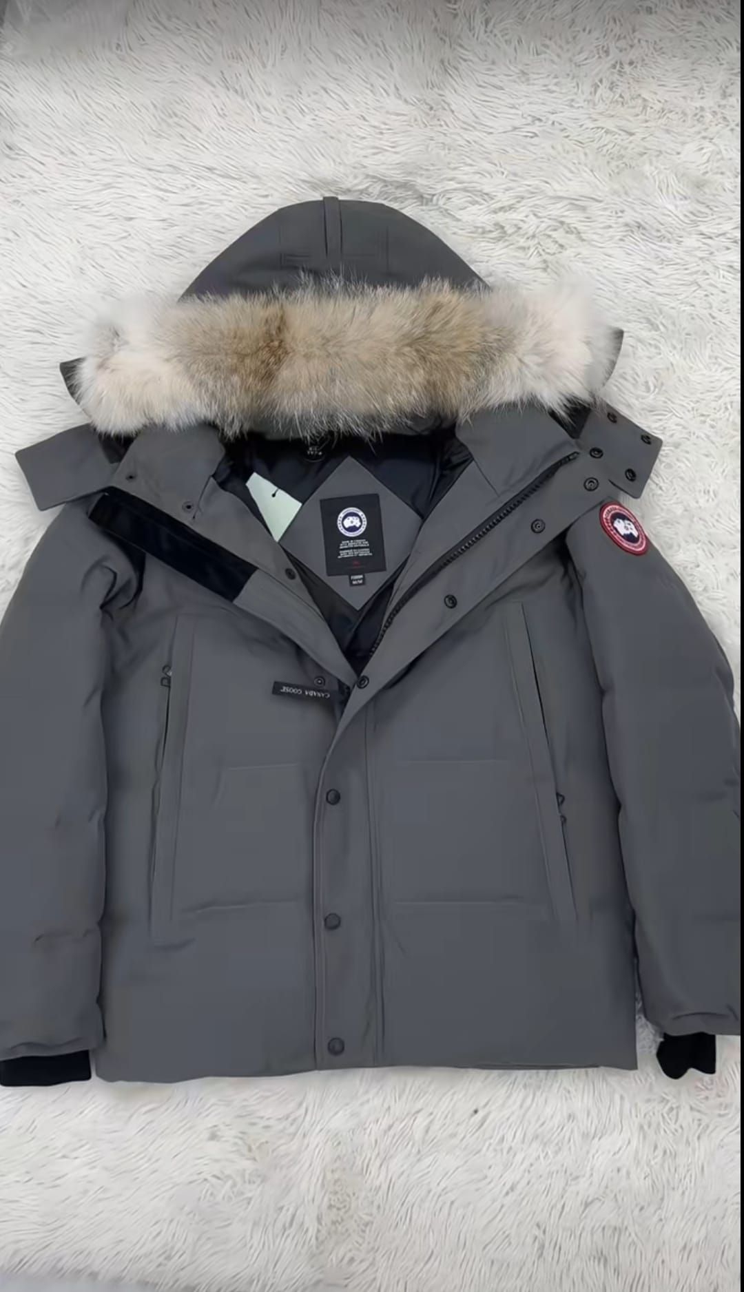 Gray parka with fur-lined hood on a white background